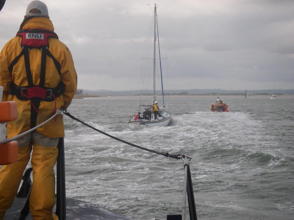 Voluntary Worker following Hayling Lifeboat towing Pupsick